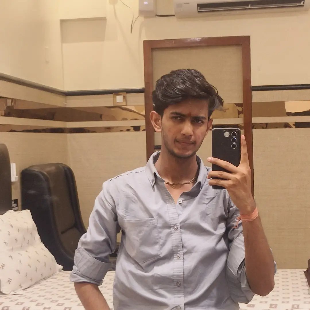 Mirror portrait of Anish in a blue shirt